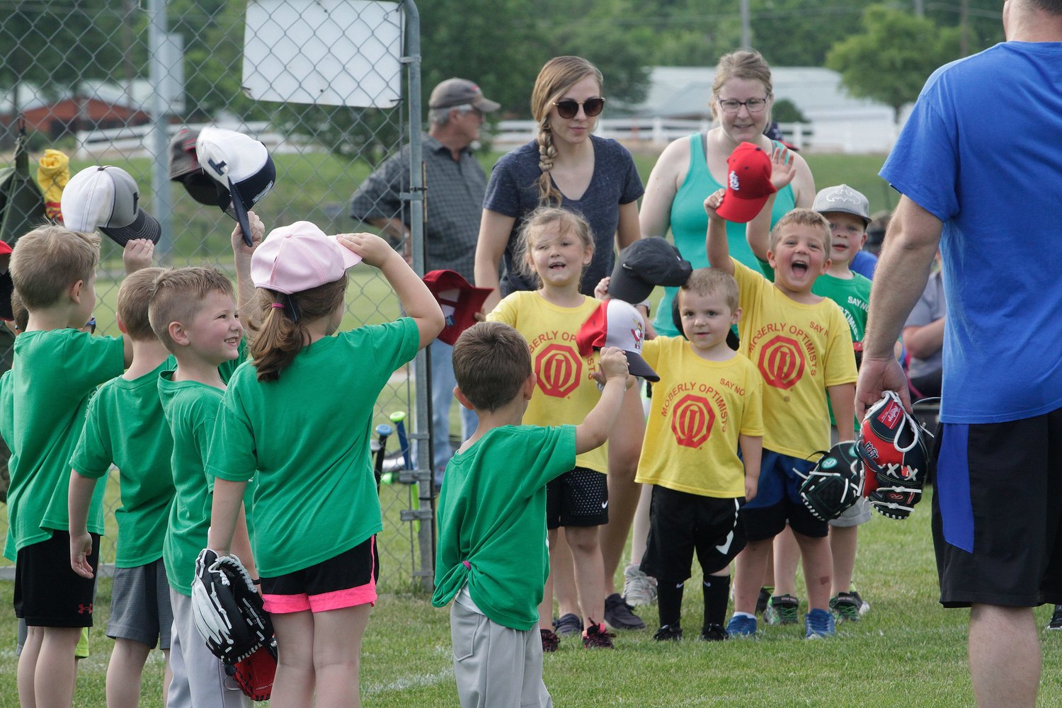 Players with the Huntsville Hawks (green shirts) and Higbee Tigers age 4-5 year old teams of the Moberly Optimist Club T-ball League salute one another following a league game played this summer at the Howard Hils Athletic Complex.