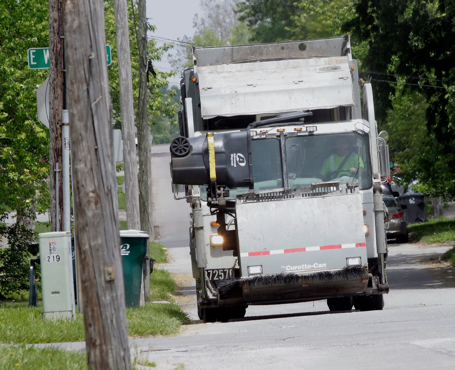 A driver with Advanced Disposal &amp; Waste Management Co. operates an automatic lift arm to grab a Moberly resident's trash container and dump its contents into a storage unit Wednesday. The Moberly City Council meets June 7 and is considering to amend its service agreement with Advanced Disposal that may affect changes in how local residents dispose of their trash items.