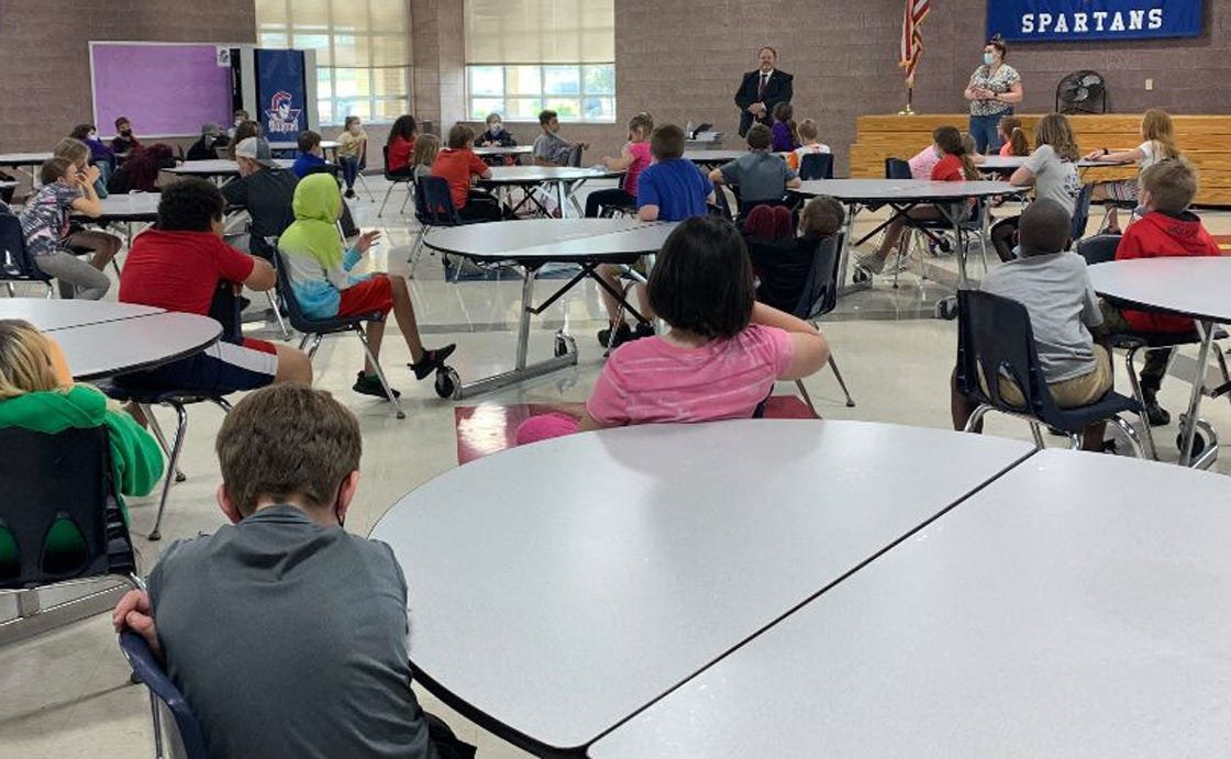 Missouri State 6th District Representative Ed Lewis of Moberly stands in front of 5th grade students at Gratz Brown Elementary School as he talks about the state's legislative process and answers students' questions.