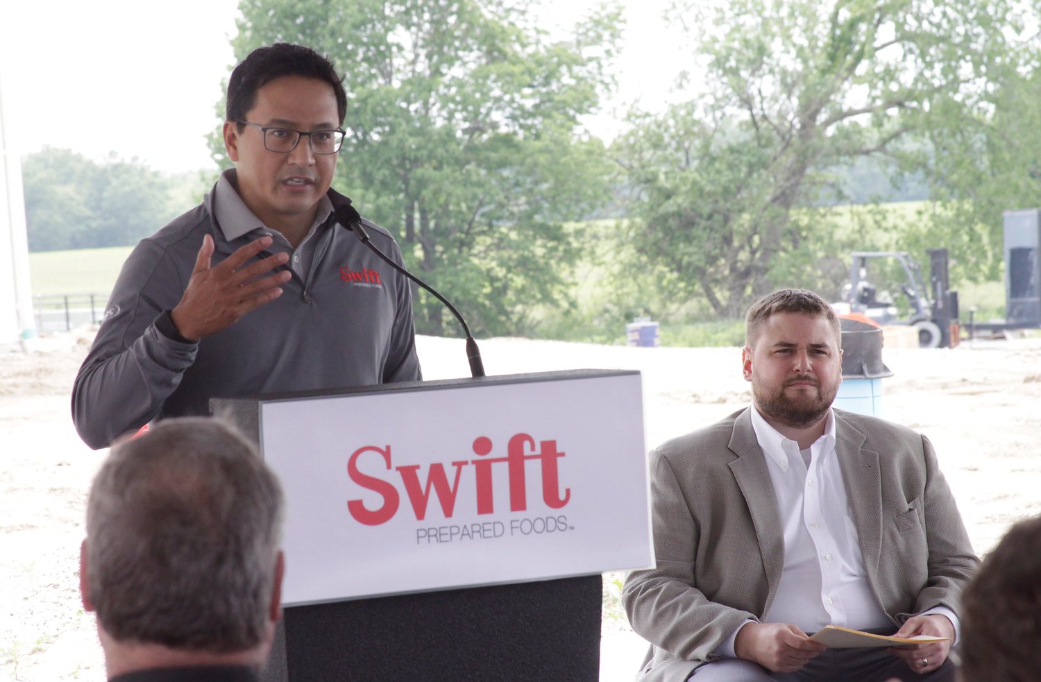 Tom Lopez, president and chief operating officer, Swift Prepared Foods, talks about company values and goals as it begins operations to produce ready-to-eat bacon products at its new facility in Moberly.  Shown seated is Moberly Area Economic Development Corporation President Michael Bugalski.