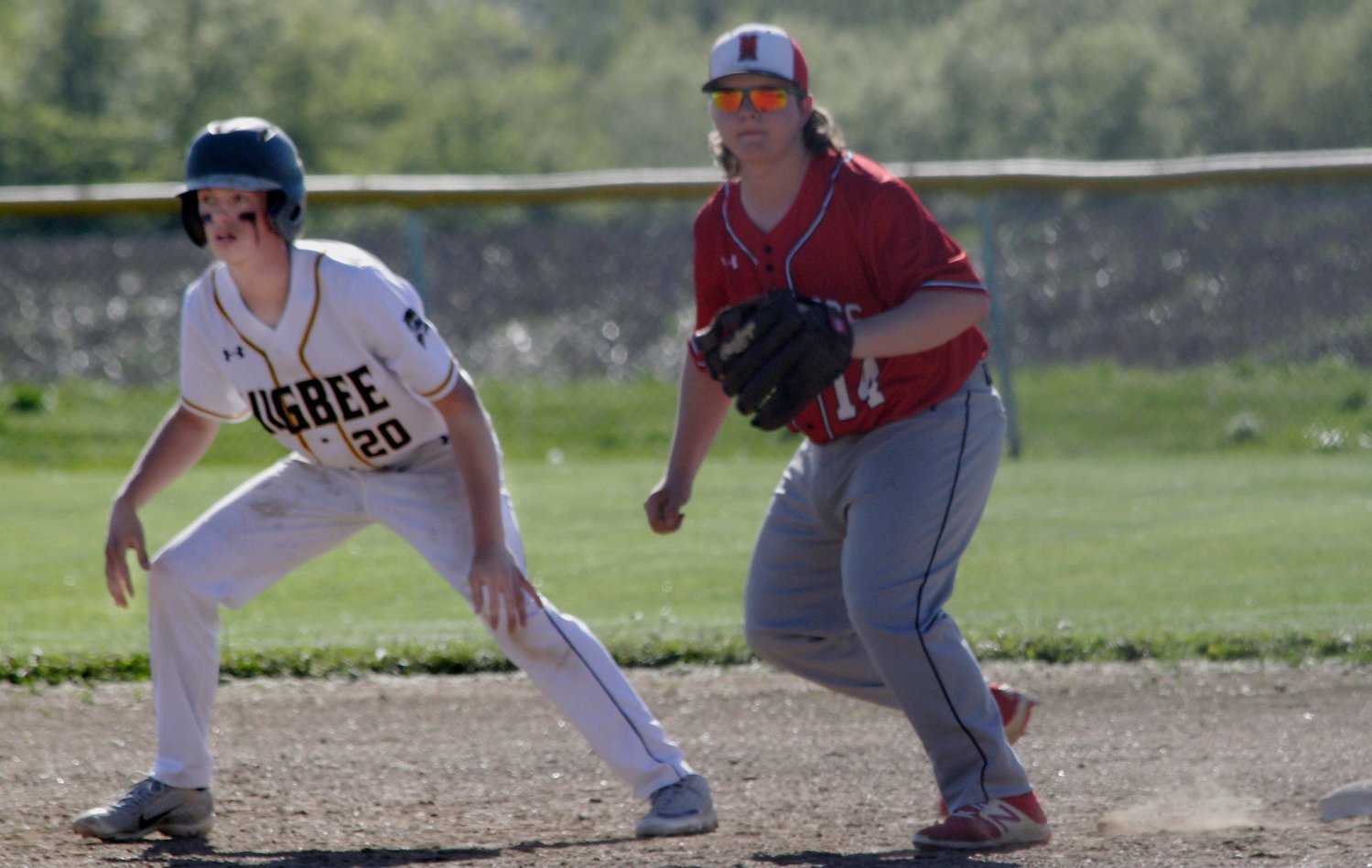 Ernie Boggs of Higbee (#20) extends his lead from first base Friday while Marion County first baseman Jonathan Goodwin moves into defensive position. Boggs and the Tigers baseball team suffered a`12-2 home loss to the Mustangs from Philadelphia in 5 innings.