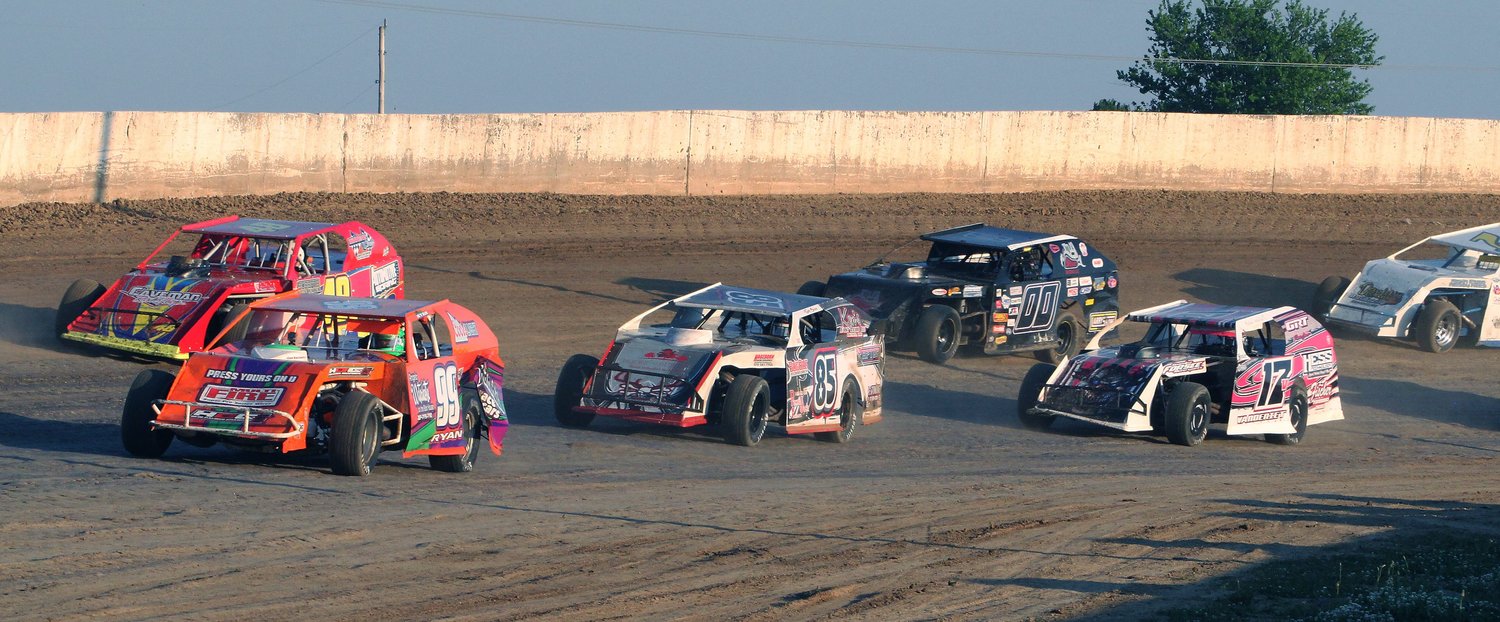 A pack of A-Modified drivers make their way around Turn 2 at Randolph County Raceway in Moberly during a June race held in 2020.