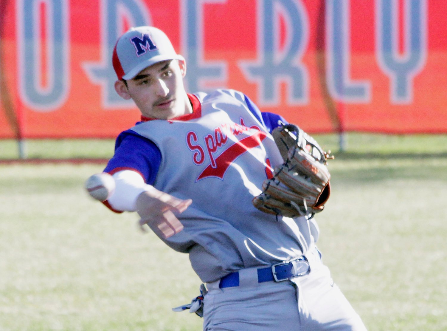 Moberly second baseman Chris Coonce leans backwarrd as he makes a throw to first base Monday during the Spartans 10-3 home baseball loss to Kirksville.