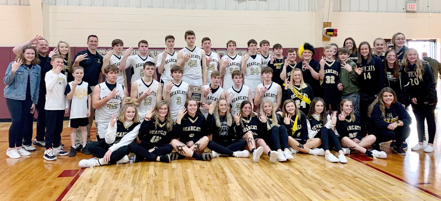 The 2020-21 Northeast R-IV School at Cairo boys basketball team defeated Scotland County of Memphis 60-33. The progrram led by head coach Nic Zenker celebrates its Class 2 District 6 tournament championship  having players from the Lady 'Cats team and other supporters join them for a post-game group photo.