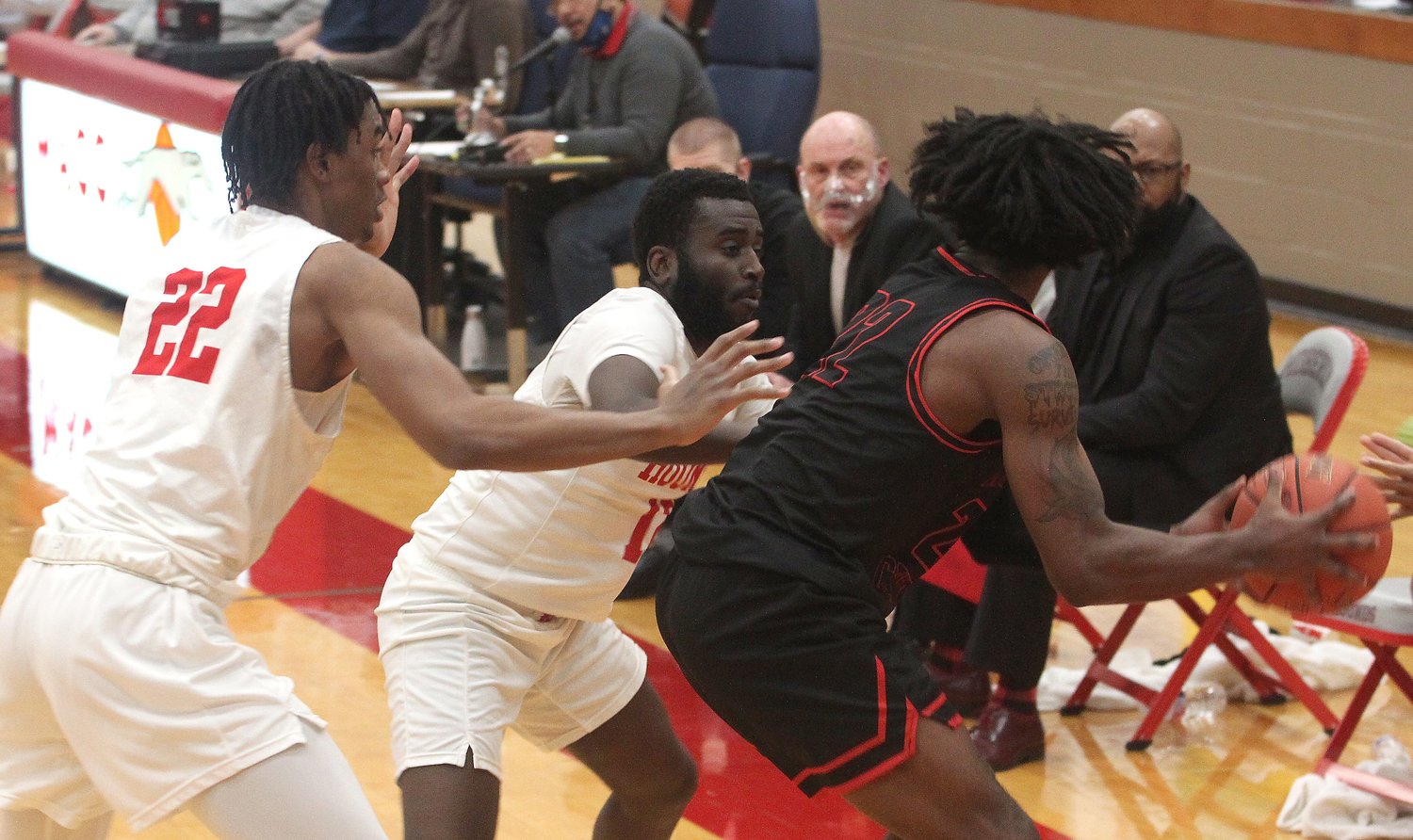 Moberly Area Community College's Makalani Kafele (#22) and Tyen Moore trap Atavian Butler of North Central Missouri College in Trenton (with ball) while the Greyhounds apply a full court press Tuesday. MACC men needed overtime to grind out a 110-109 home triumph against the Pirates.