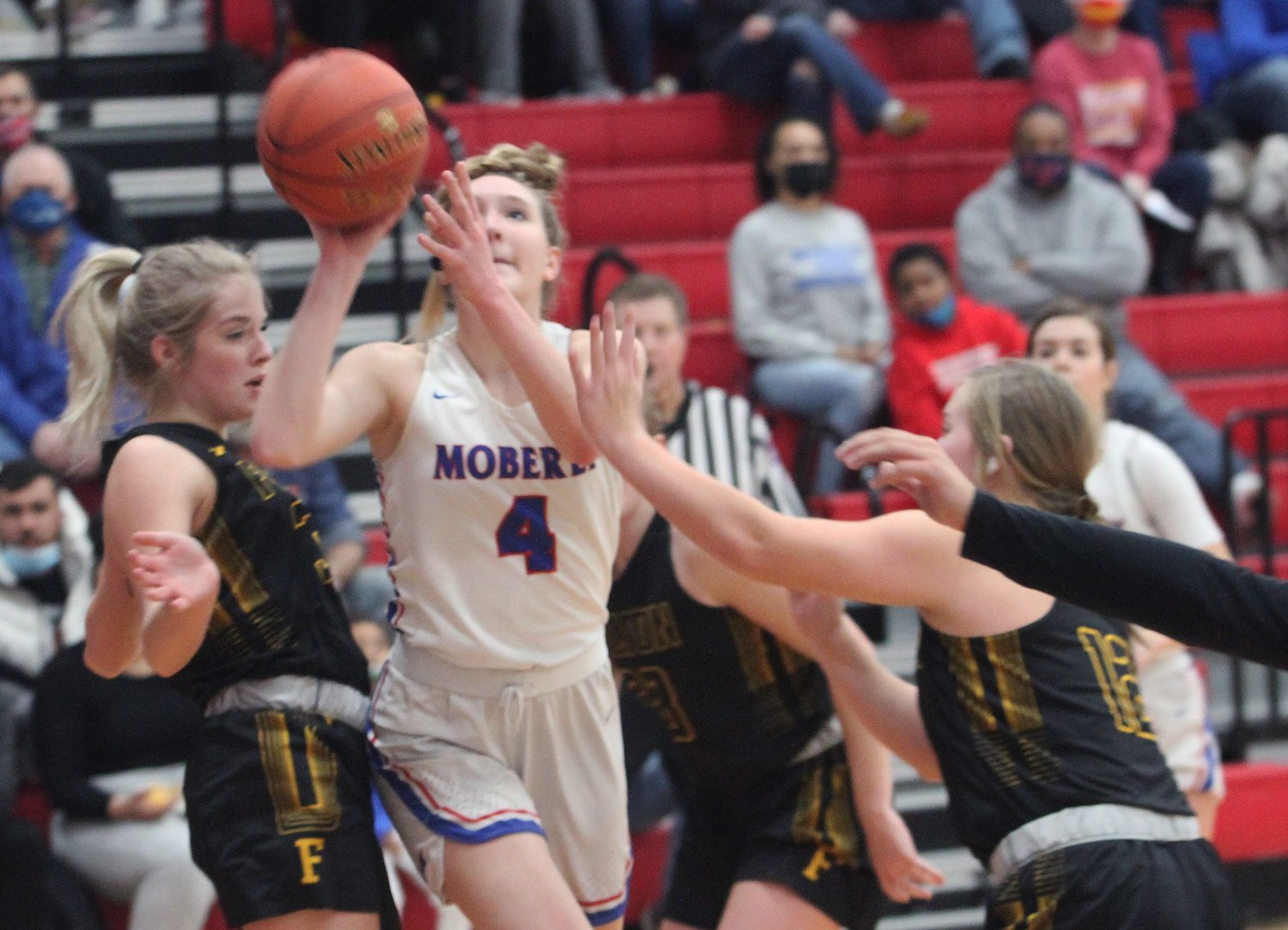 Moberly freshman Asa Fanning splits the seams of a pair of Fulton defenders Friday as Fanning makes her way toward the rim. Fanning scored seven points during the Lady Spartans 51-32 Winter Homecoming loss to the Hornets.