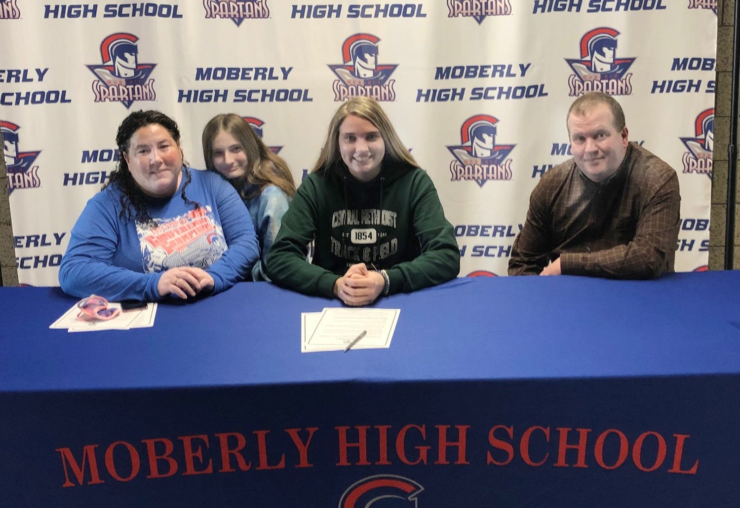 Moberly High School senior Isabella Ross signed a letter of intent on Jan. 29 announcing she accepted a cross country and women's track scholarship while attending Central Methodist University in Fayette for the 2021-22 college year. Isabella is seated between her mother, Tiffany  Ross (left) and Rob Kloski, and behind her mother is Isabella's freshman sister Chloe.  Ross qualified for the MSHSAA Cross County Championships all four varsity years under Spartans head coach Greg Carroll.