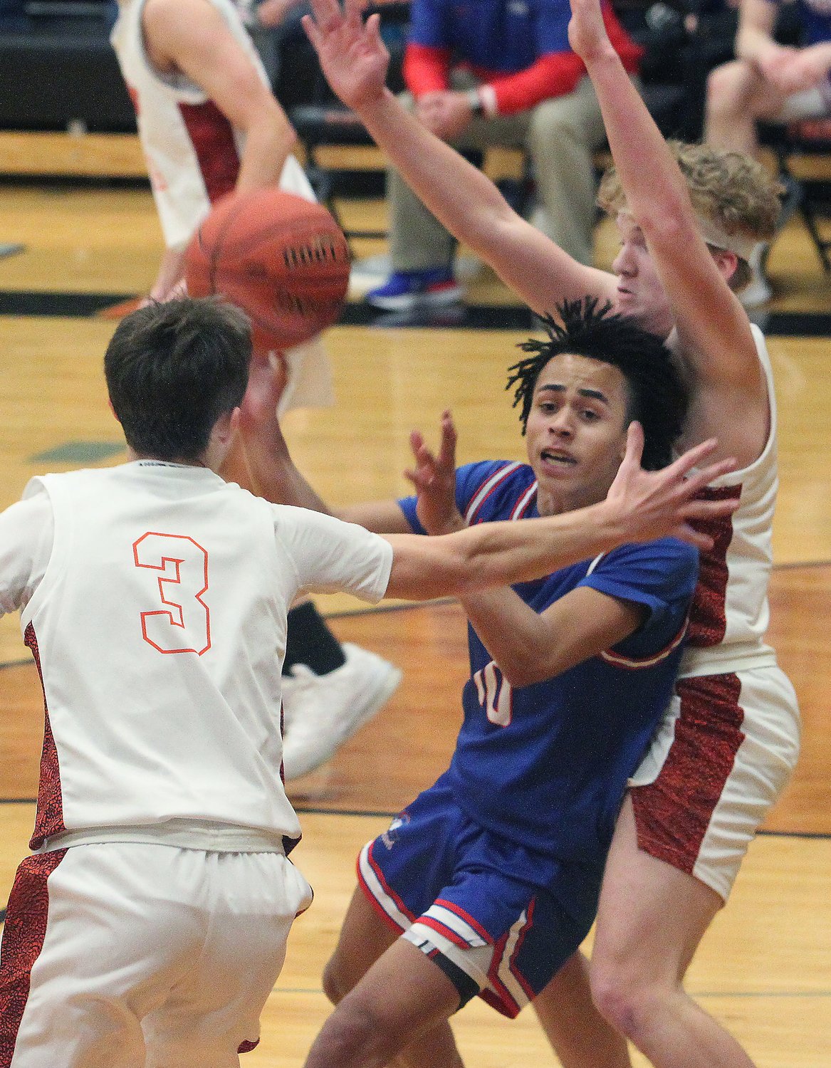 aisten Payne (#10), a Moberly junior point guard, looks to pass the ball to an open teammate Saturday as he is defended by Kirksville's Lane Keeney and Isaac Danielson (#3) during the boys championship game of the Macon Tournament. Payne netted a game-high 24 points in the Moberly loss.