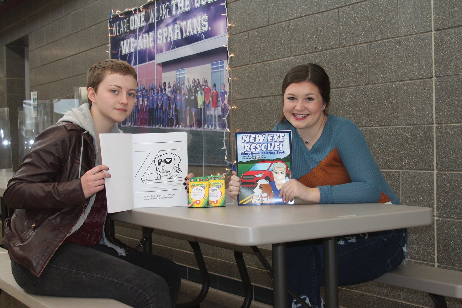 Moberly High School junior Bailey Hurt, left, and freshman Camryn Crist teamed up to create an educational children's coloring book named New Eye Rescue that is being given away free to students in grades K-3.