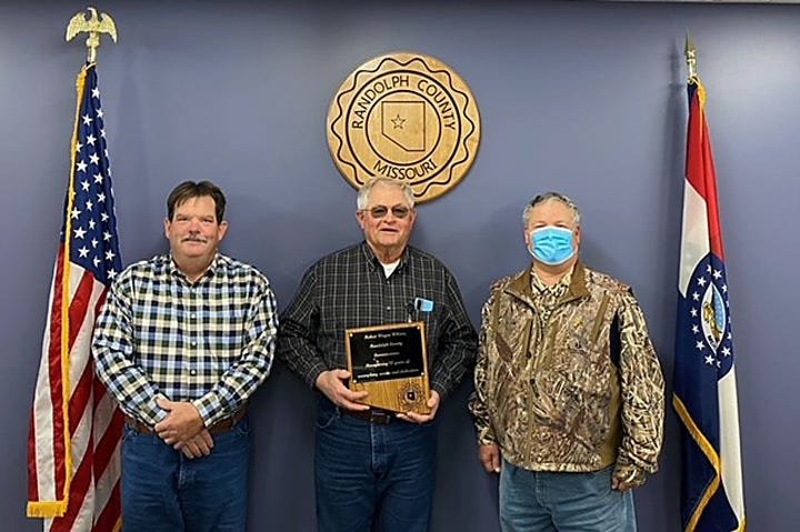 Wayne Wilcox, Eastern Randolph County Commissioner, center, was honored Monday with a plaque for his 12 years of service to Randolph County Commission.  Wilcox is retiring Dec. 31. He is joined by Western District Commissioner John Hobbs, left, and Presiding Commissioner John Truesdell.