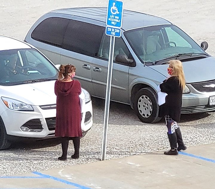 A bipartisan couple of election officials stand curbside at the Randolph County Justice Center in Huntsville accepting absentee ballots from a registered voter in advance of the Nov. 3 General Election.  (Courtesy of Randolph County Clerk's office)