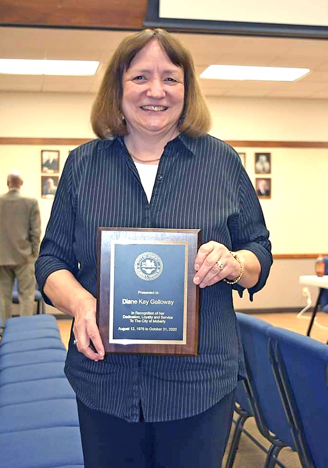 Moberly City Clerk Kay Galloway holds a plaque of appreciation Monday for her 44 years of service she received during the Moberly City Council meeting. Galloway will retire Nov. 1.