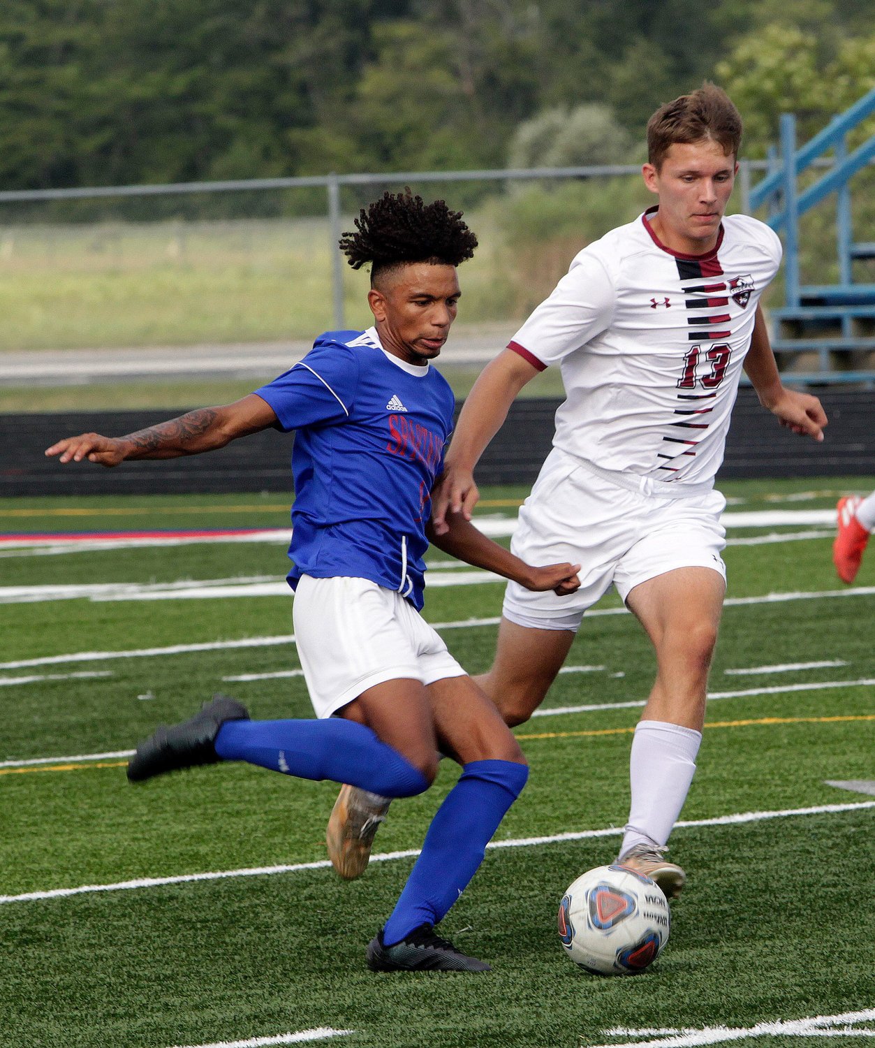 Moberly High School senior forward Charez Nichols sends the soccer ball upfield to a teammate Tuesday during the Spartans 8-1 home victory against Canton. Nichols netted three goals and had two assists for the cause.