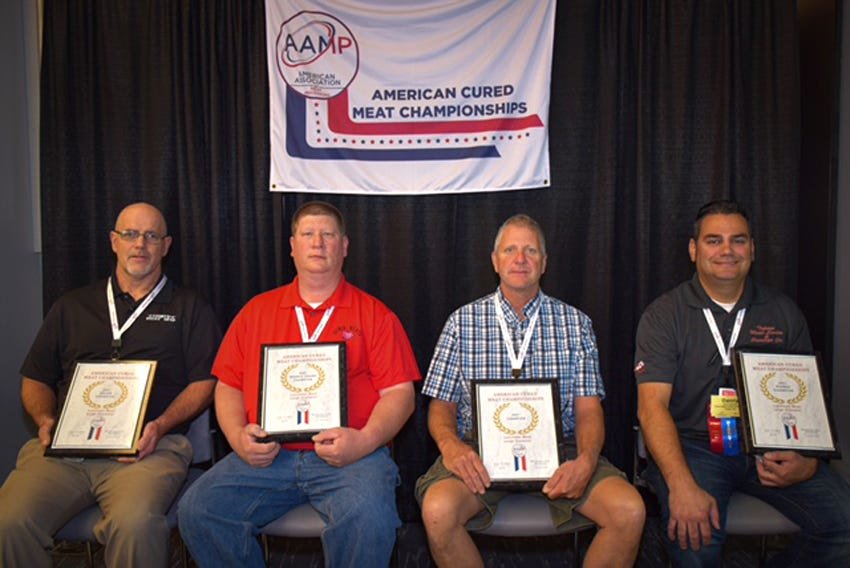 Mark Reynolds, left, owner of Country Meat Shop in Moberly, won awards in eight different categories of meat products at the 2021 American Cured Meat Championships held July 15-17 in Oklahoma City, Okla. Reynolds is shown seated with other business winners associated with Dewig Meats, Haubstadt Ind.; Newhall Locker, Newhall Ia; &amp; Tulare Meat Locker, Tulare Ca.