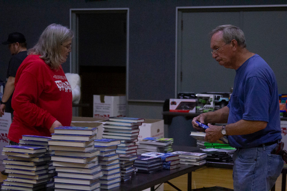 Dorothy Latson and Eric Land arrange a display of books.