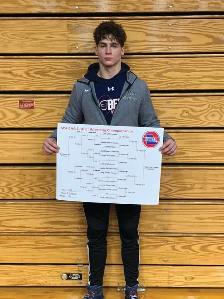 Zach Lewis displays the 170-pound district tournament bracket after winning the title at Saturday’s meet. Lewis is one of seven wrestlers for Moberly who qualified for this week’s state meet. (Photo courtesy of Moberly Spartan Athletics/Activities Facebook page)