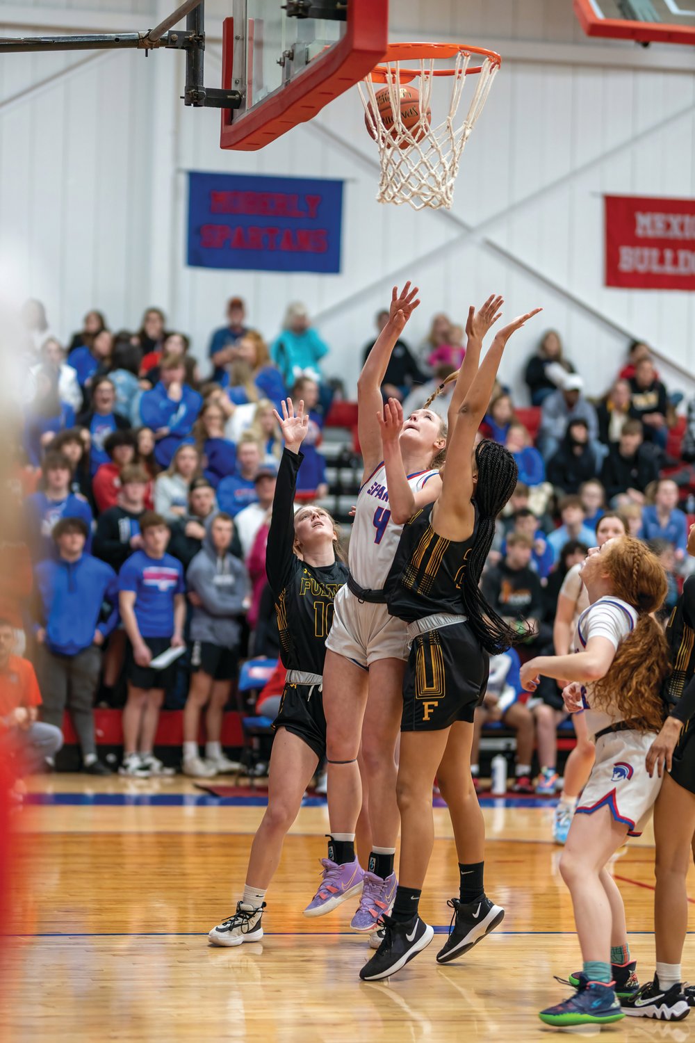 Moberly sophomore Asa Fanning scores two of her 10 points in Tuesday’s 67-34 victory at home over Fulton. The win give the Lady Spartans a share of the NCMC title. (John Wright Photography)