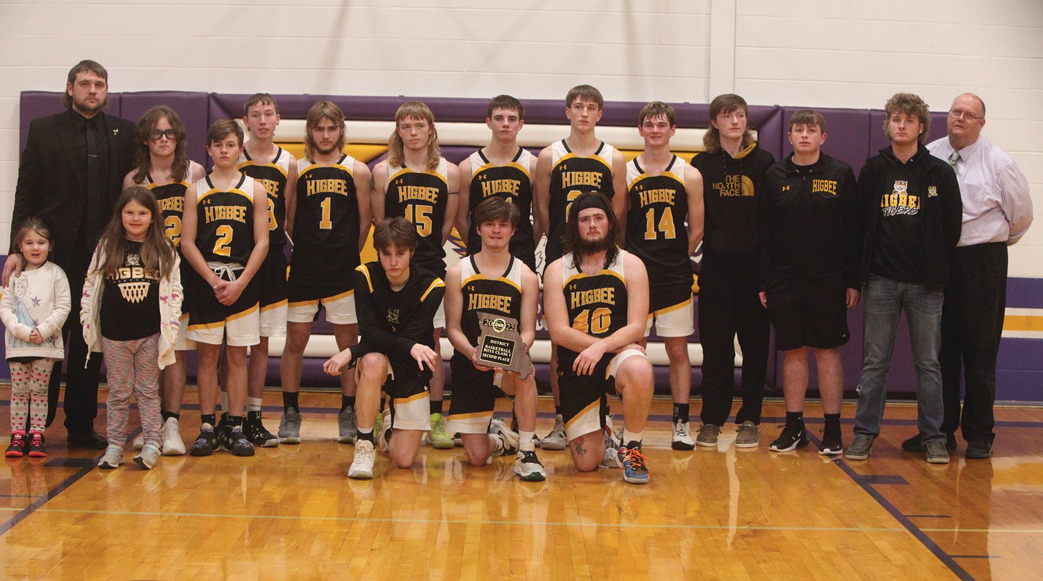 The Higbee boys basketball team poses with its second-place trophy after losing to Wellsville-Middletown 38-34 in the Class 1, District 10 finals on Feb. 25 at Pilot Grove High School. THEO TATE PHOTO