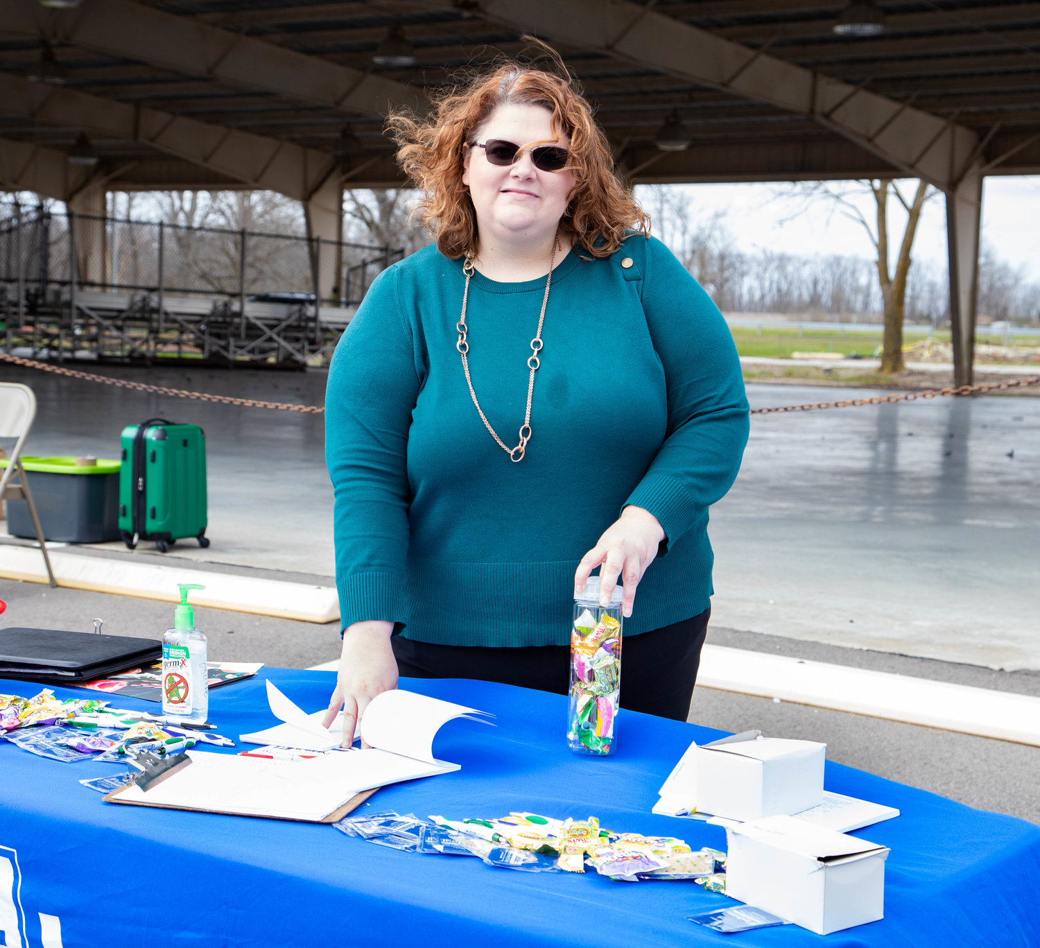 Stephanie Hall, business development specialist with Job Finders, fights the wind during Wednesday’s Moberly Area Chamber of Commerce job fair at Rothwell Park in Moberly.
