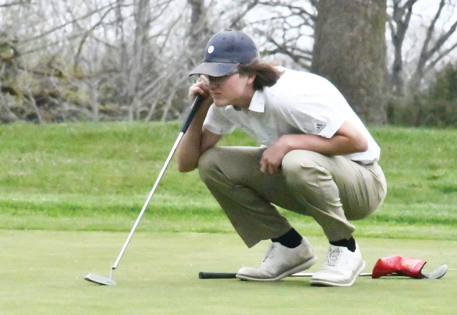 Westran’s Logan Bain examines a putt on the par-5 Hole No. 2 at Heritage Hills Golf Course in Moberly during a quadrangular last Thursday. Bain was the medalist with a nine-hole score of 38.