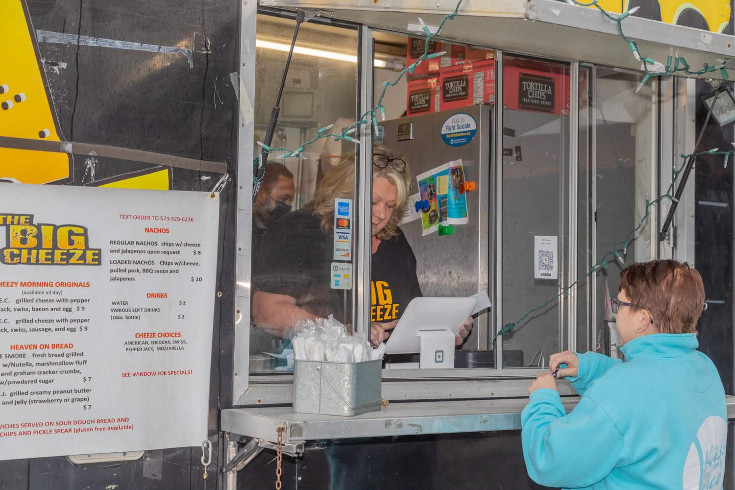 The Big Cheese serves a customer during the Street Food Throwdown at The Fennel Wednesday in Moberly. A short rain met the opening of the event but moved out in time for Concannon’s performance. Organizers estimated that nearly 1,000 people attended.