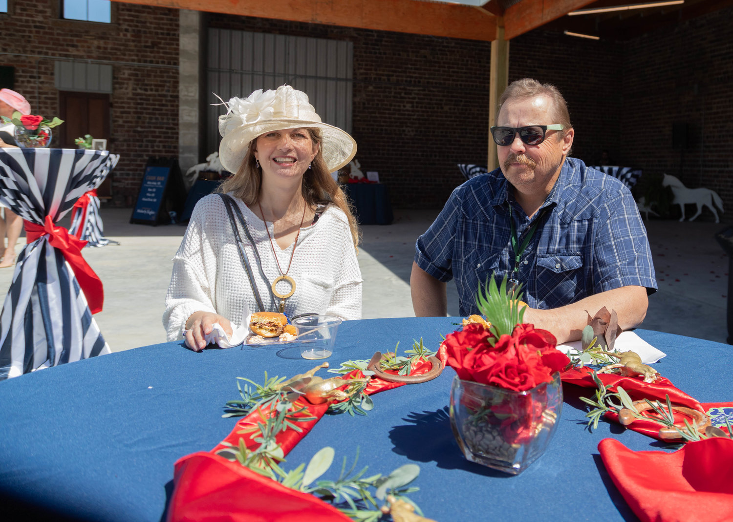Tammy and Steve Greenwell find a seat in the sun Saturday before the Moberly Area Chamber of Commerce banquet. Jazz music, bourbon and wine tasting and horse-themed games kept guests entertained until time for the awards ceremony and the viewing of the Kentucky Derby.