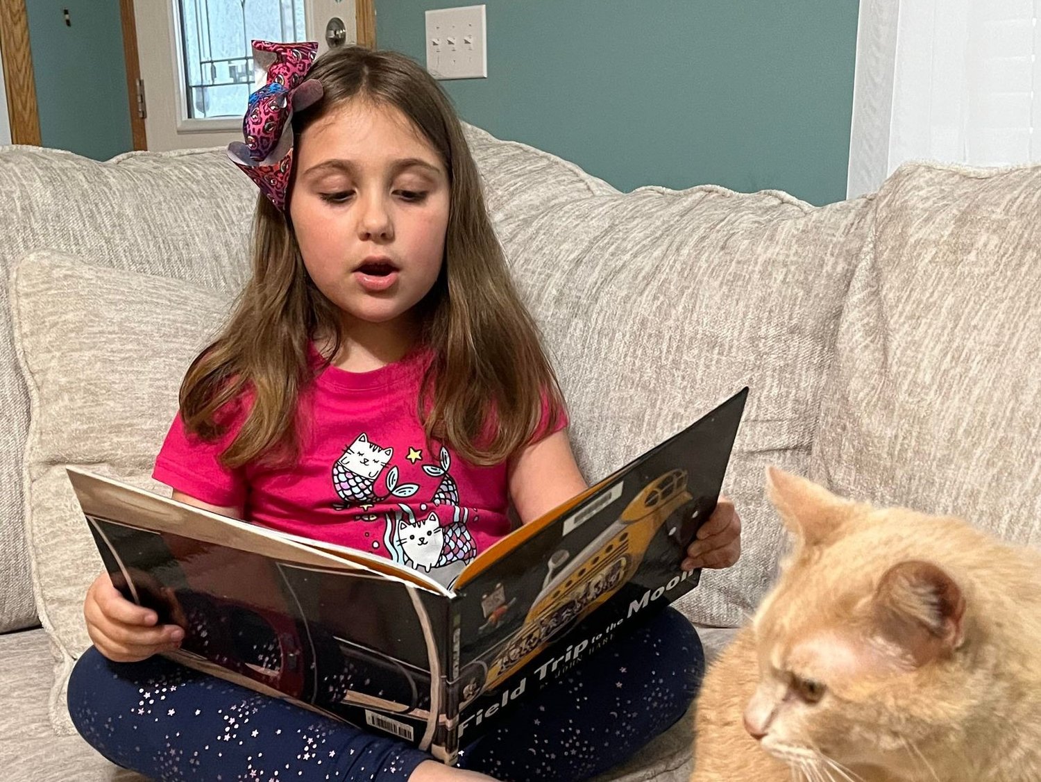 A child reads “A Field Trip to the Moon,”  a wordless picture book. There is no right or wrong way to read a wordless picture book, says Children’s Librarian Yasmeen El-Jayyousi.