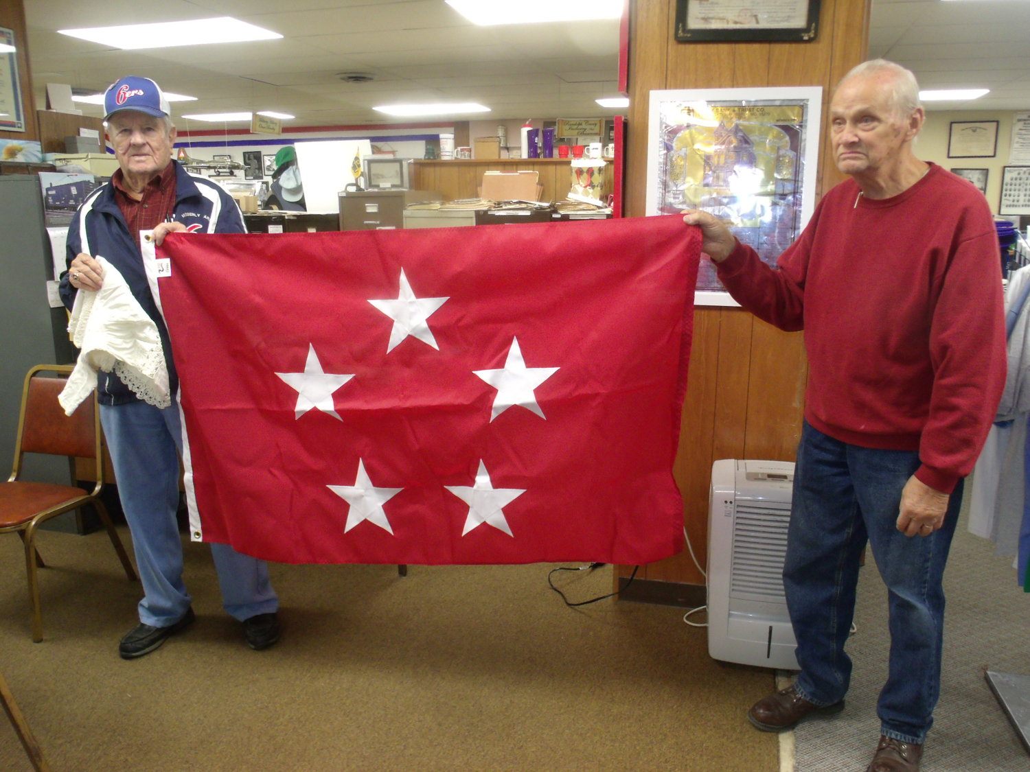 Donald P. Fuller I and David Campbell show the 5-star flag that honors Gen. Omar Bradley at the Randolph County Historical Society Museum. The museum will host a 5-star celebration honoring military heroes for Armed Forces Day.