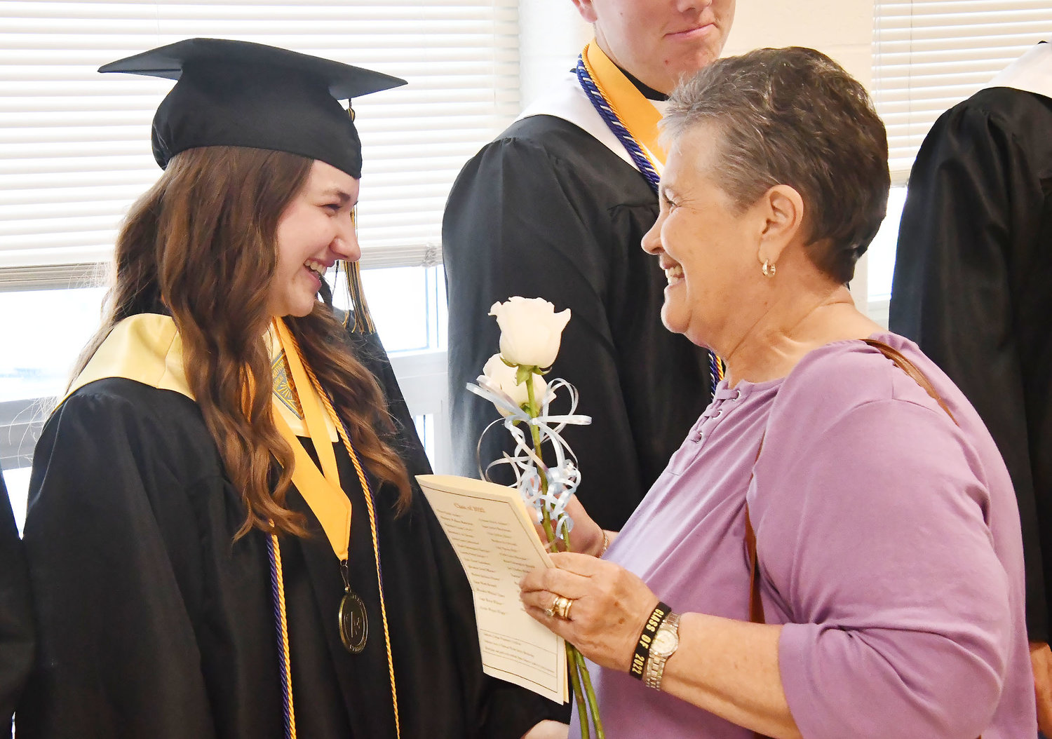 Class of 2022 graduate Lilly Hale smiles during the greeting line after Sunday's commencement exercises.