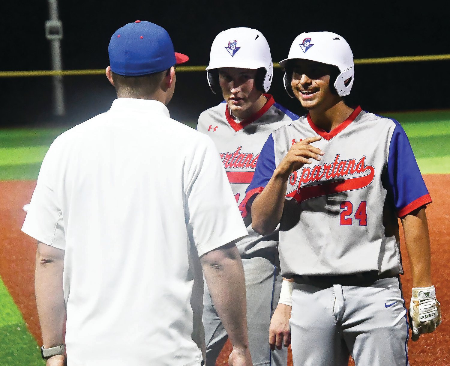 Moberly baseball players Connor Tenney (14) and Chris Coonce (24) share a laugh with head coach Tony Vestal during Monday's Class 4 District 7 championship game. Tenney and Coonce played their final scholastic contest.