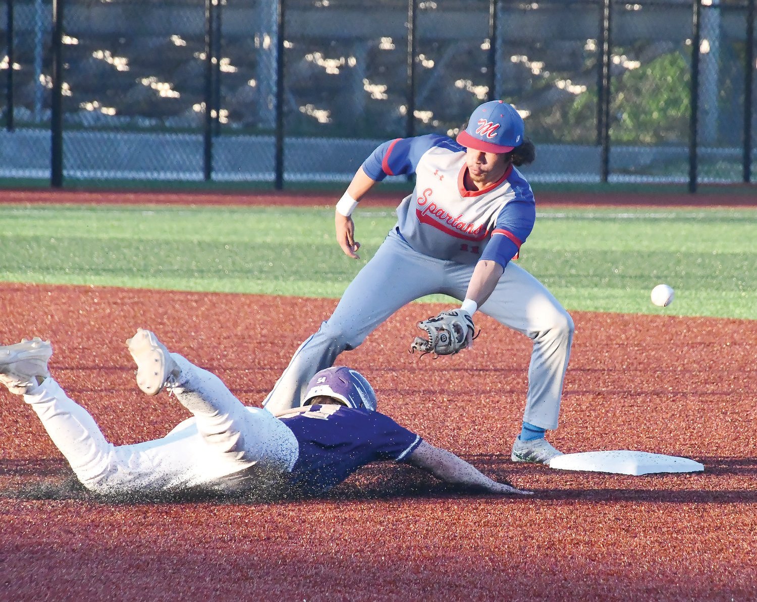 The ball squirts free from Moberly shortstop Kobe Graves while trying to tag out a Hallsville base runner during Monday's Class 4 District 7 championship.