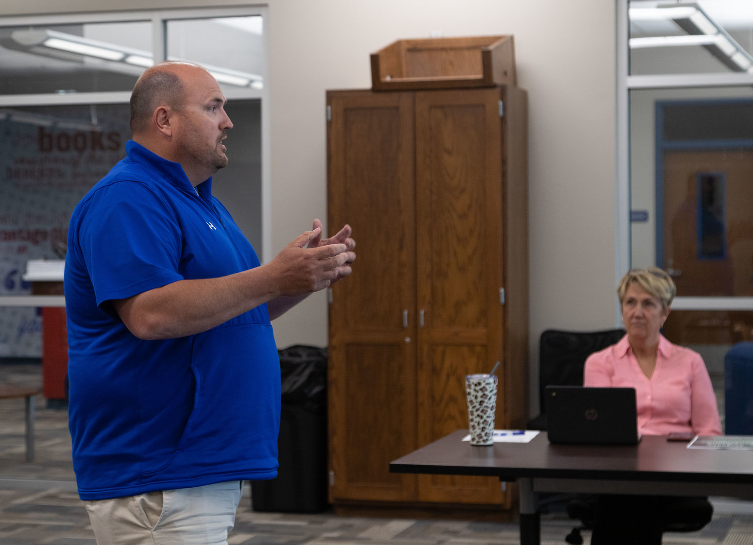 Moberly School District Activities Director Curtis Walk explains to the school board last month why the high school needs new scoreboards for Spartan Stadium and for Moberly High School gymnasium.