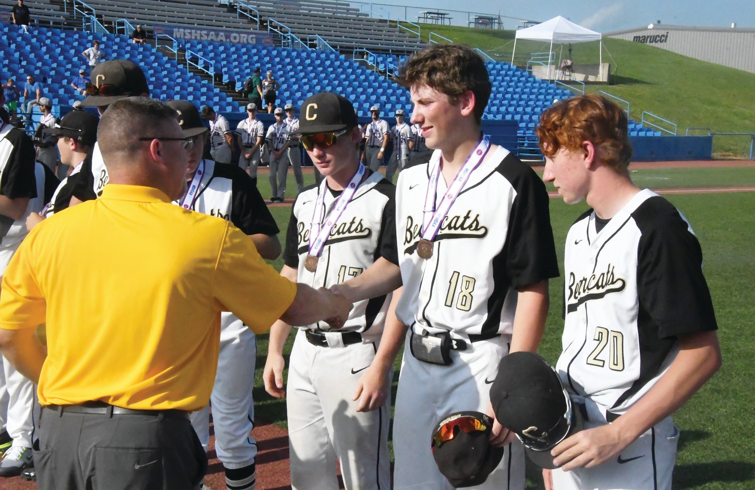 Cairo's Bryce Chrisman shakes hands with a representative from the Missouri State High School Activities Association after the Bearcats defeated South Nodaway, 9-3, in the Class 1 third-place game.