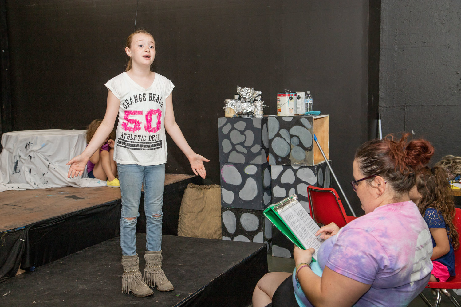 Zoe Shuerger has help with her lines from Stephanie Davis during rehearsal for The Wizard of Oz.