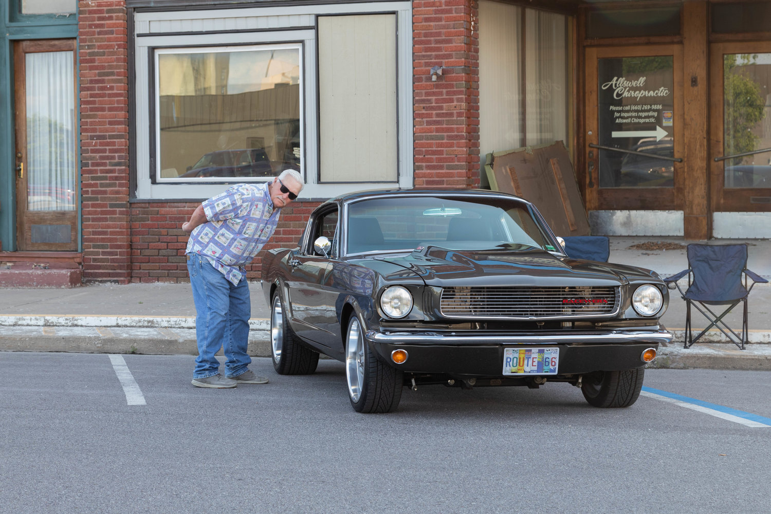 Tony Gamman checks out Bruce Barkelew’s 1966 Ford Mustang fastback on Clark Street in Moberly. Barkelew, of Columbia, brought his vintage vehicle to the Friday Night Cruise after hearing about the event at a car show last weekend.