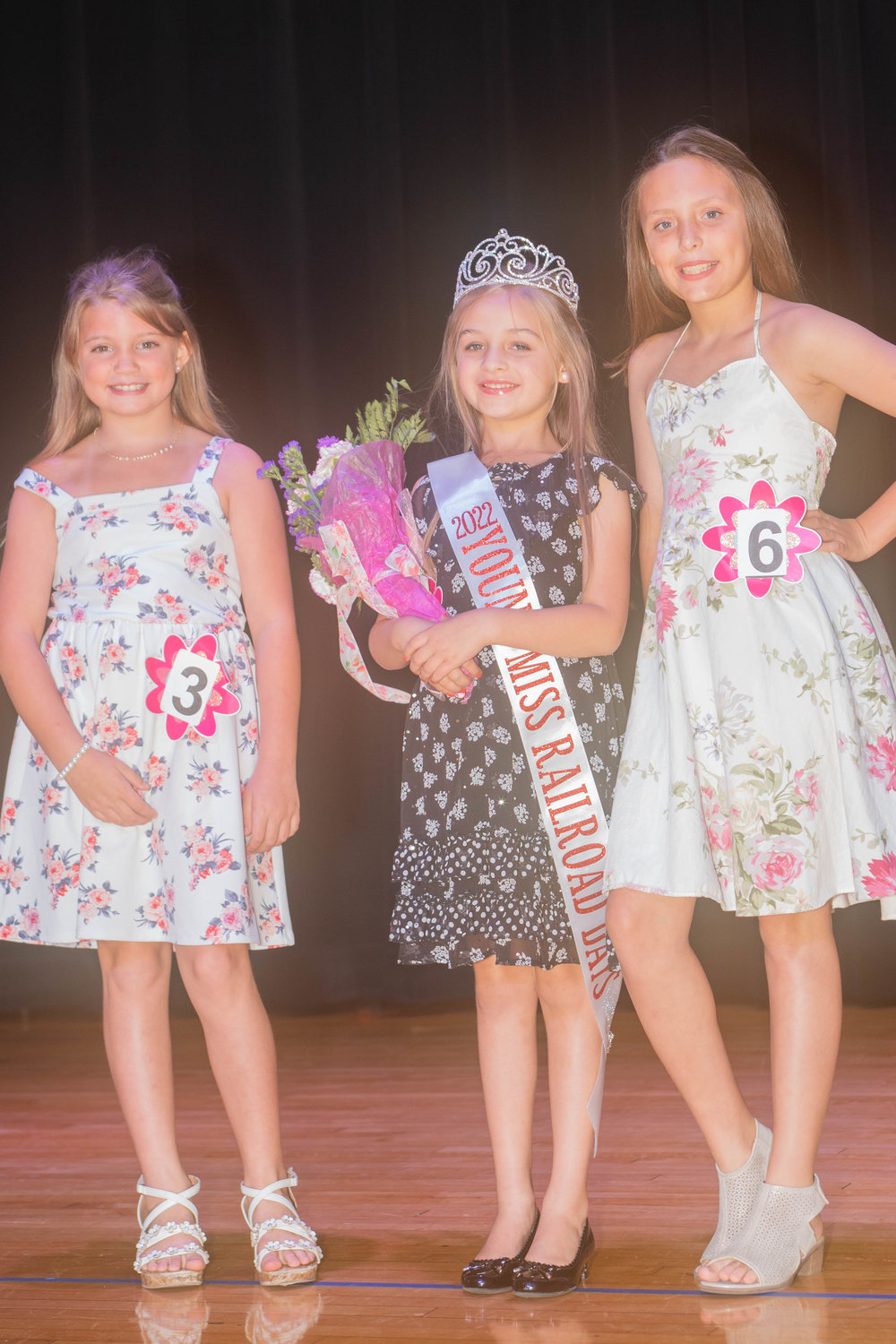Second runner up Kenlee Lawrence, Young Miss Railroad Days Georgia Graff and first runner up Teagan Neal pose for photos after the Railroad Days pageant Sunday Night.