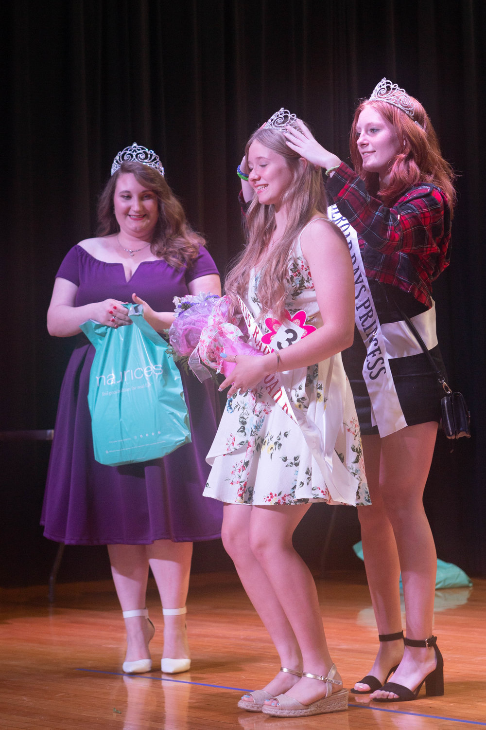 Junior Miss Railroad Days Kaleighia Brown is crowned by 2021 Princess Ashlyn Ancell as 2021 Miss Railroad Days Evelyn Ortman looks on.