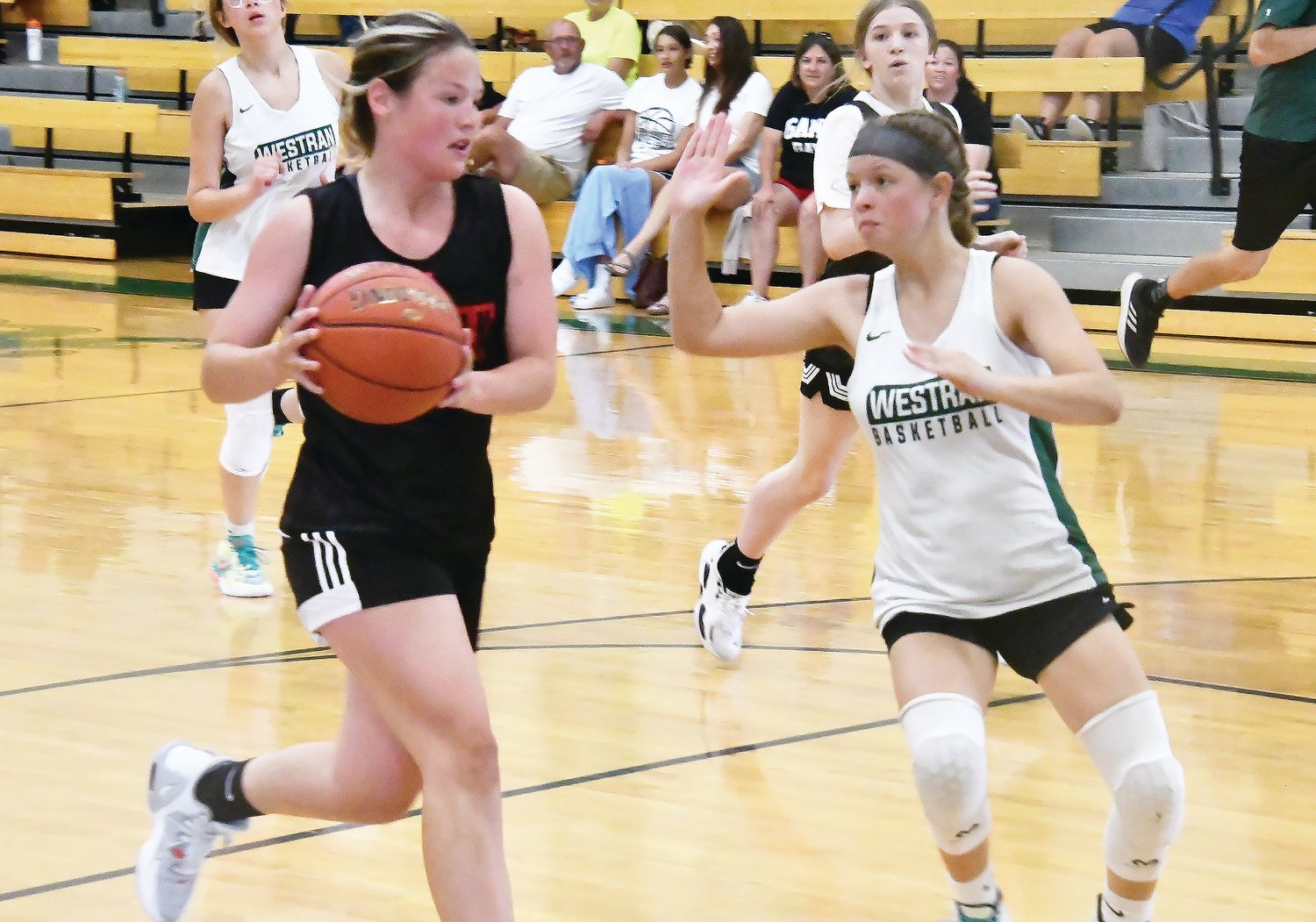 Westran's Shaylynn Morris defends while a Community R-VI player drives toward the basket during a scrimmage between the two schools on Thursday, June 9, in Huntsville.