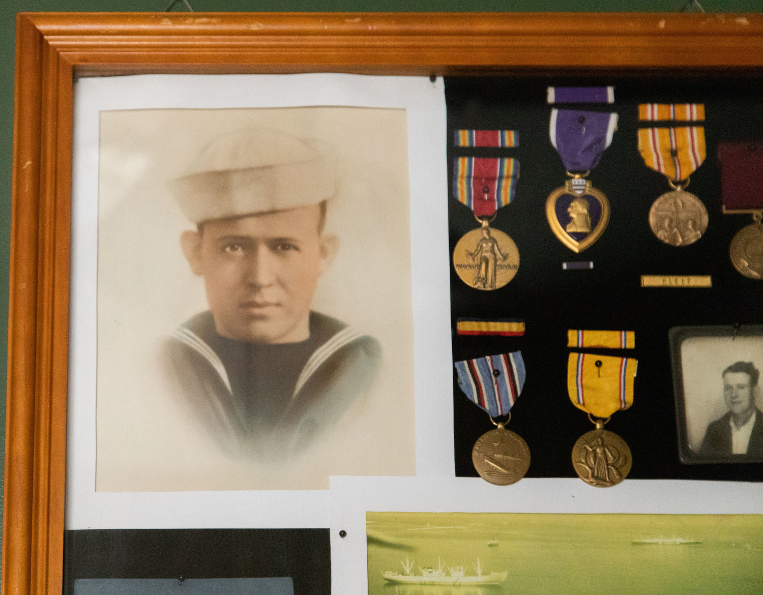 Former Moberly resident Dale Brockman displays his uncle’s photo and medals in his home in Paris. Brockman began researching the destruction of the USS Houston and the resulting fatalities about 1996 when his aunt revealed that his Uncle Clarence had died on the ship in February of 1942.