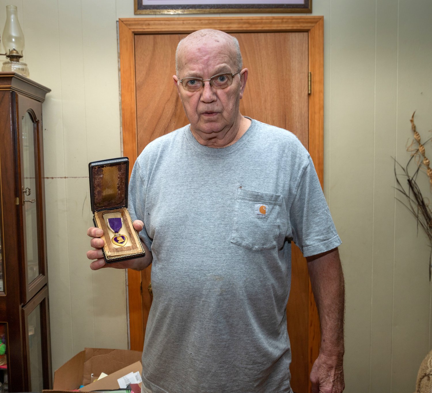Dale Brockman, of Paris, holds the purple heart awarded posthumously to his uncle Clarence.