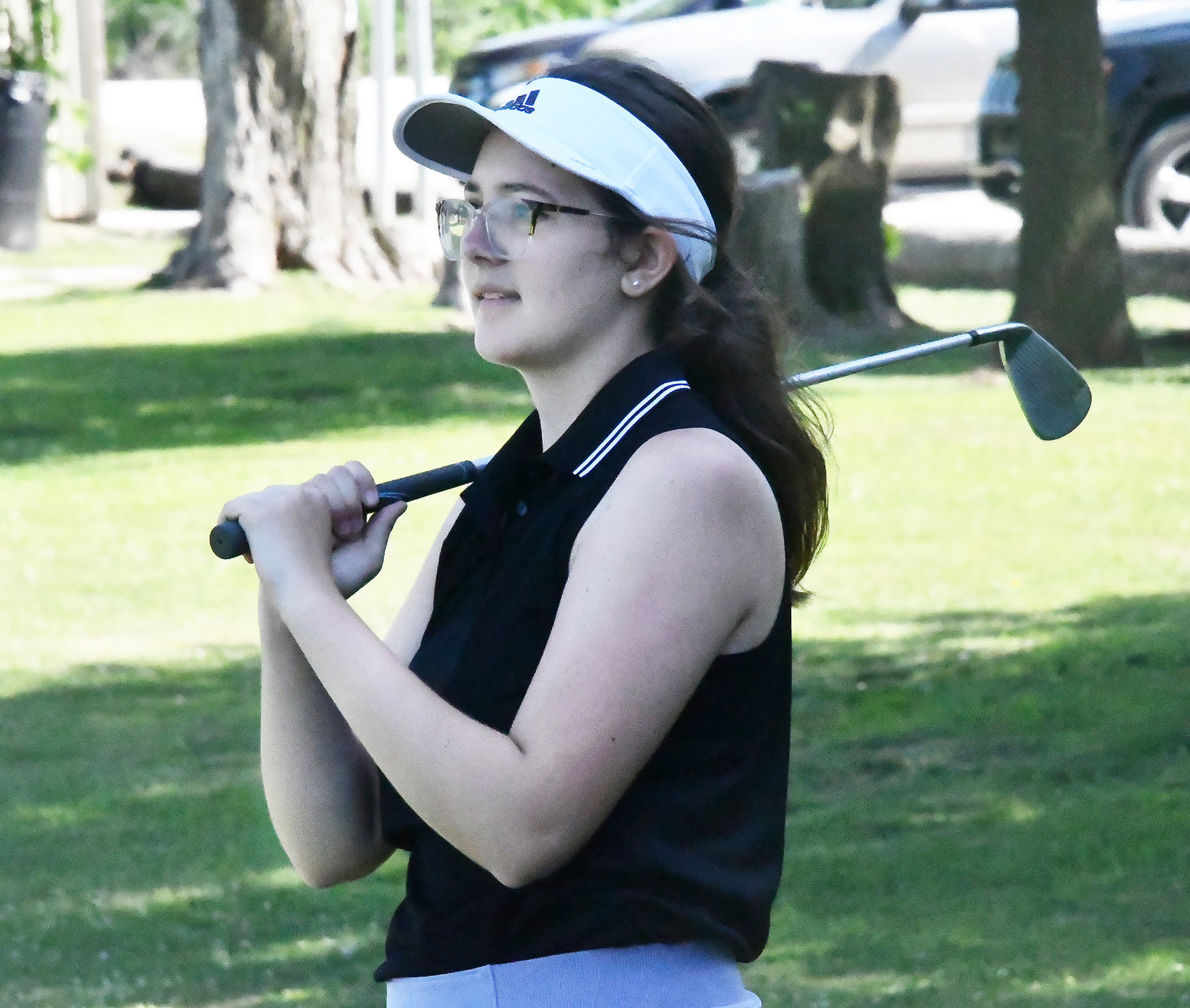 Addison Pollard smiles as she hits a long iron shot during Tuesday's one-day clinic.