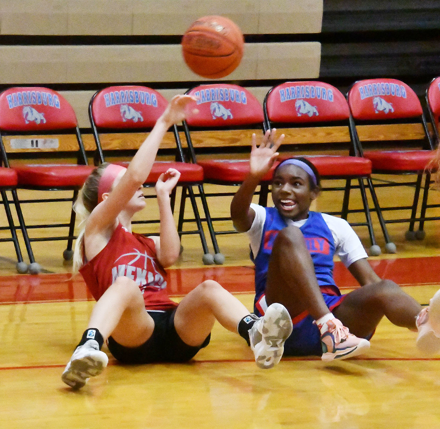 Moberly's Anyja Hayes battles for a loose ball from a seated position during a scrimmage against Mexico at Harrisburg Tuesday.
