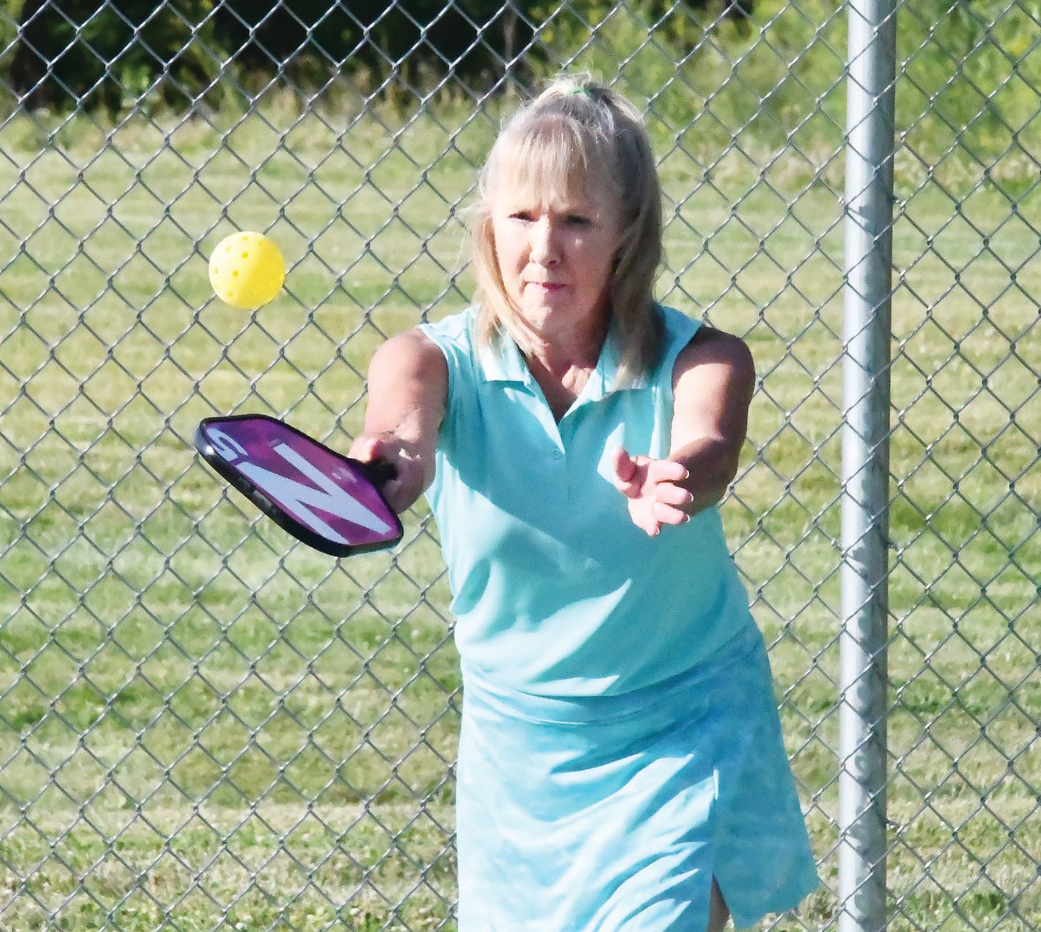 Kathleen Wilson of Paris serves during a doubles match as part of the Moberly Parks and Recreation Department’s beginners’ pickleball course on Thursday, June 16, at Fox Park off Russhaven Drive.