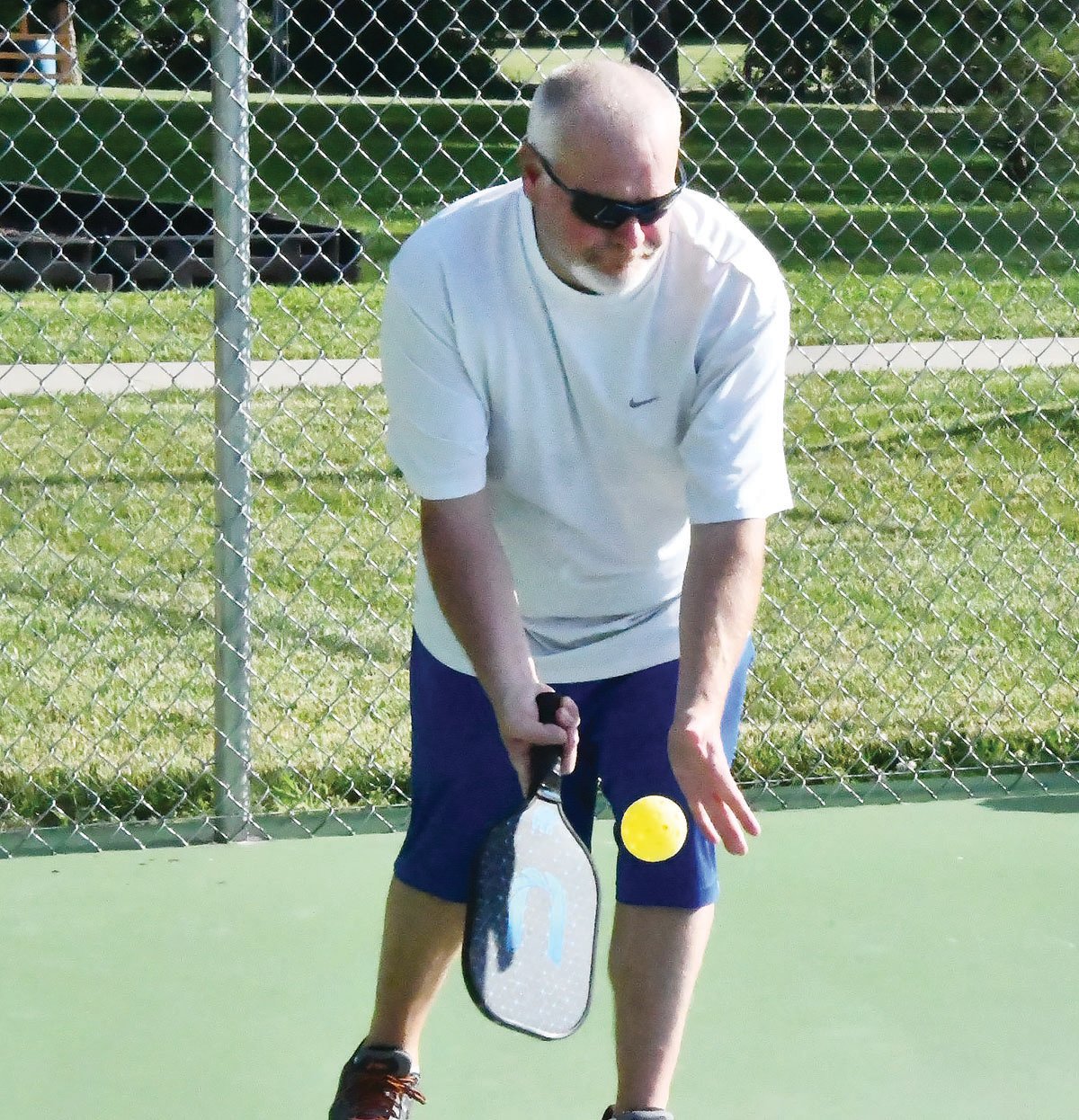 Charlie Hargis prepares to serve during a pickleball match at Fox Park in Moberly. Before the serve in a doubles match, a player will call out the score, which features three numbers.