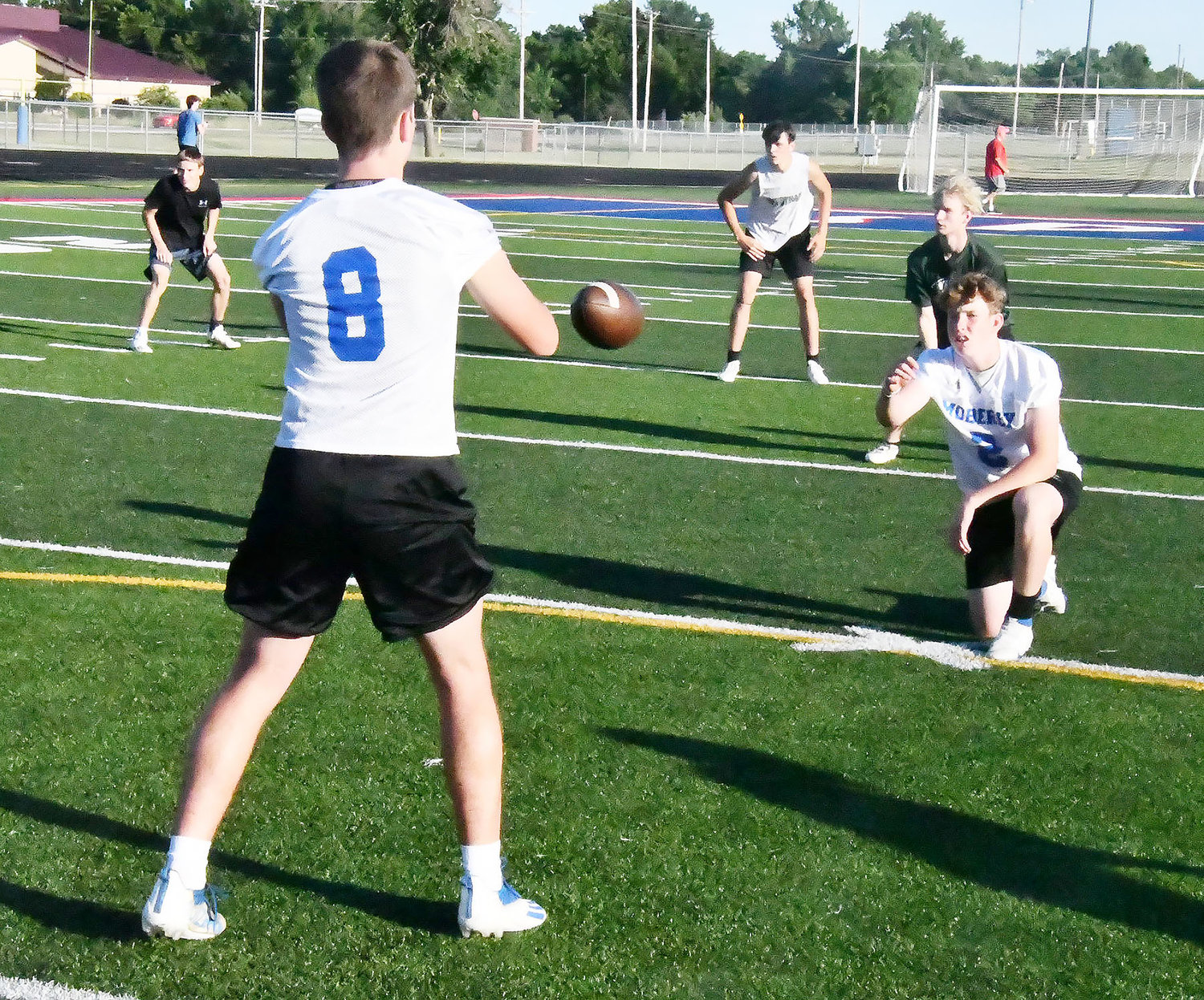 Center Jackson Engel snaps the ball to Collin Huffman to initiate a play during the 7-on-7 league on June 22.