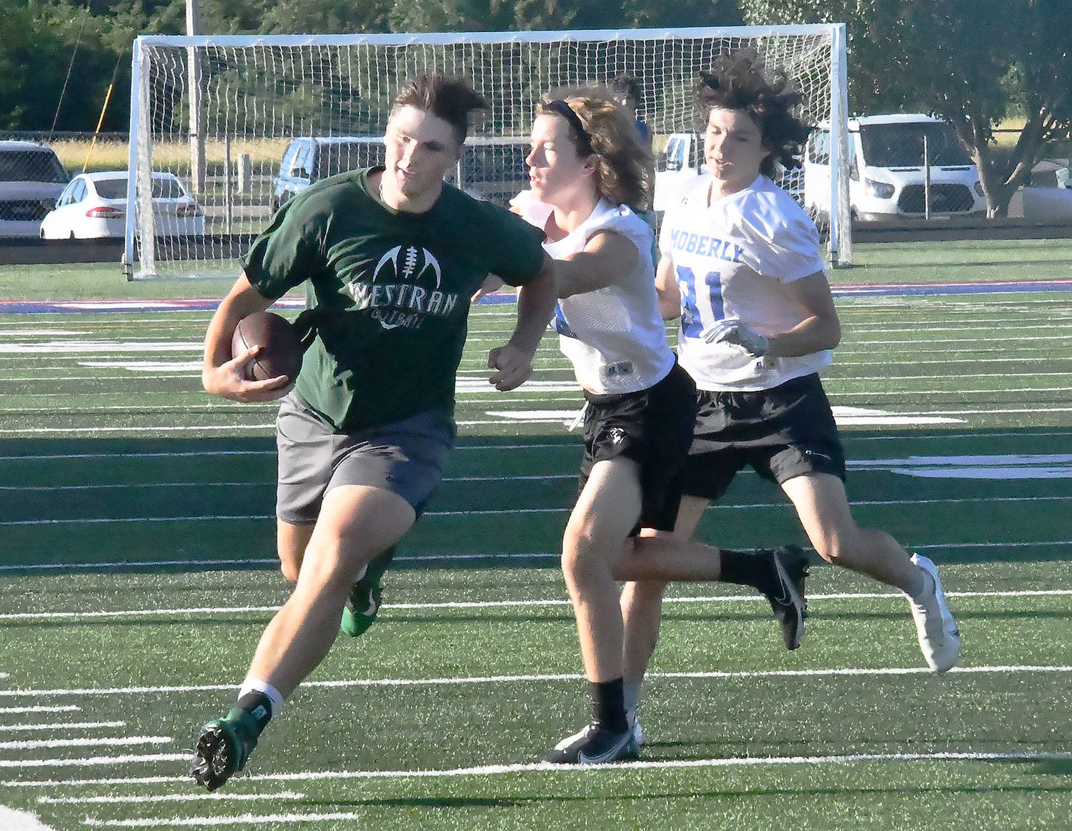 Josiah Owen and Brett Gelina force a Westran's Langden Kitchen out of bounds during 7-on-7 league action from June 22.