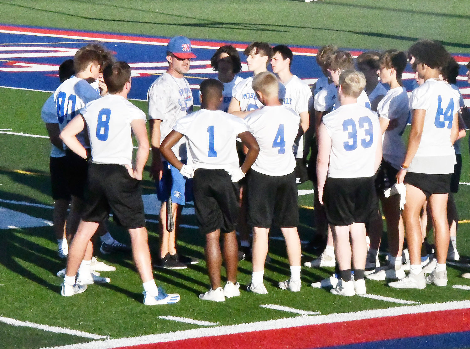 Moberly head football coach Cody McDowell talks to the players following completion of the 7-on-7 session on Wednesday, June 22.