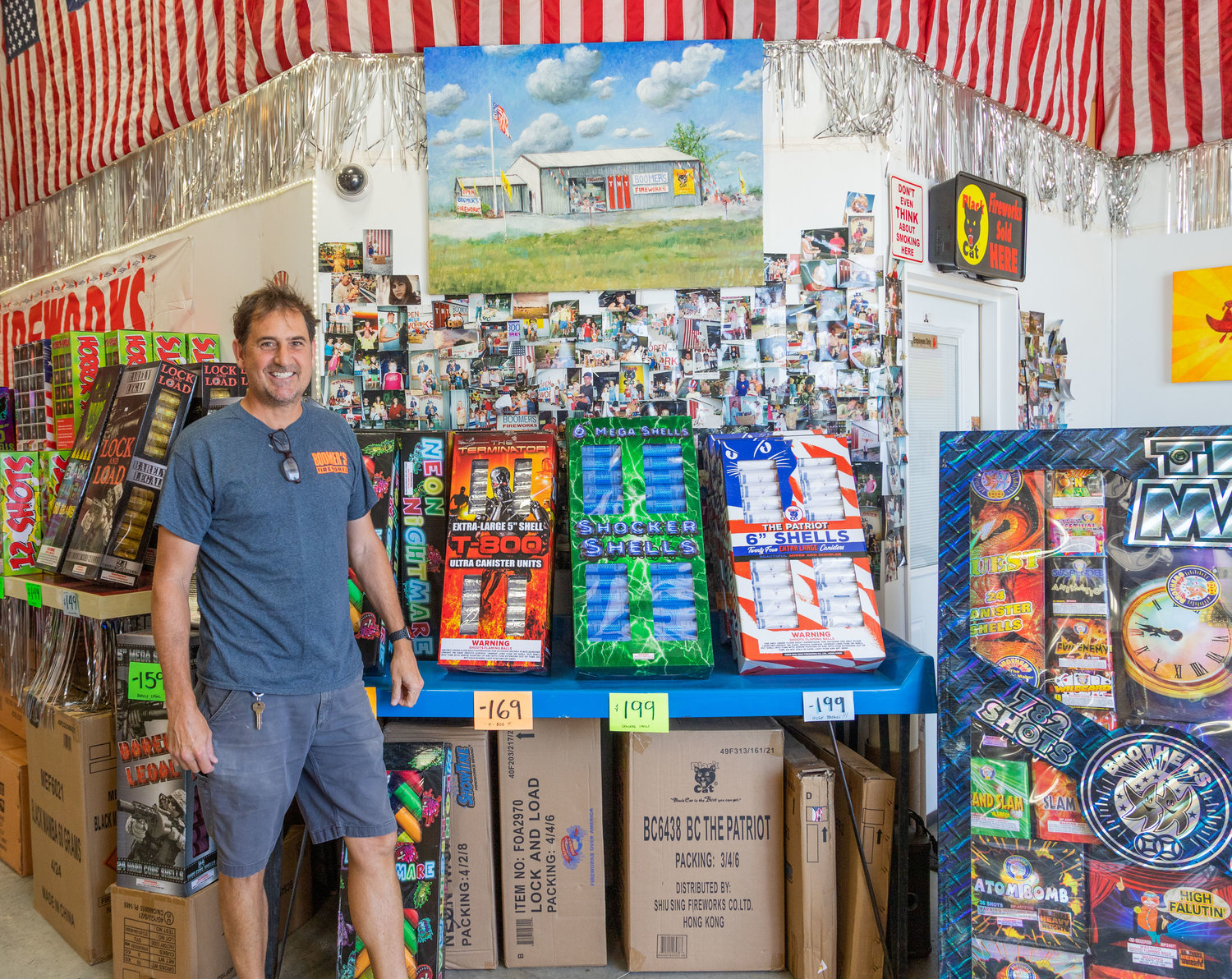 Jon Wolf shows off the photos of customers who have patronized Boomer’s Fireworks in the past 33 years. Many now have children and grandchildren who buy their fireworks from the Wolf family.
