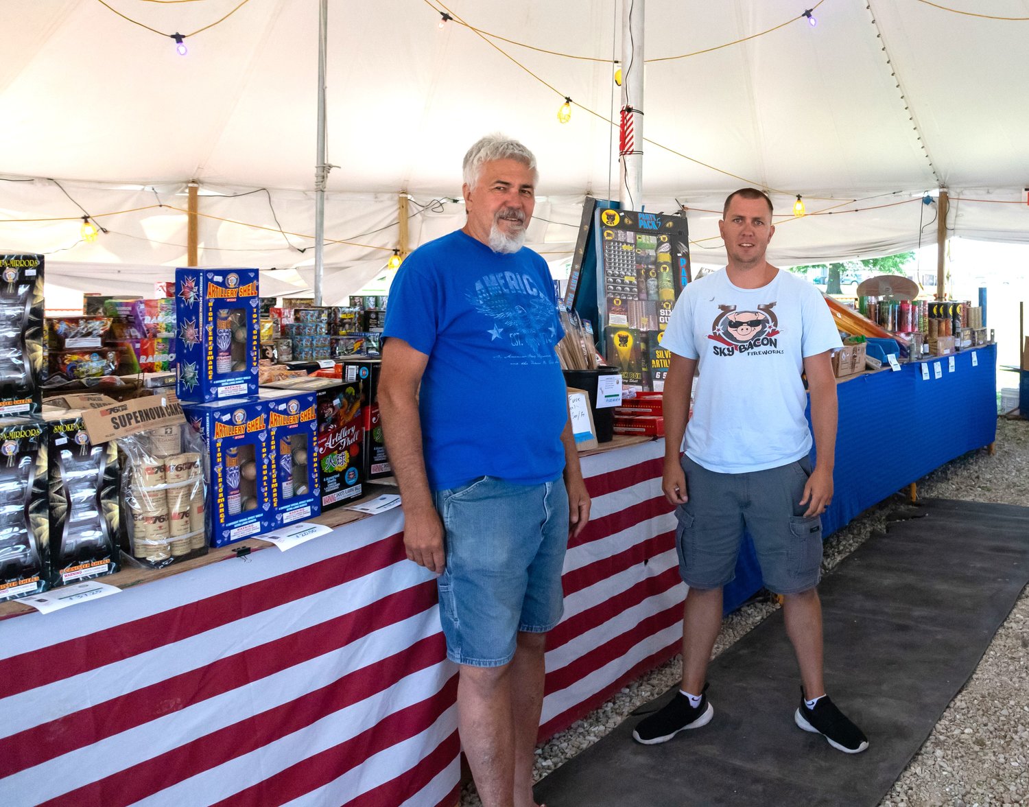 Steve Kelly and his son Jared stand amid the fireworks they sell at Kelly Brothers Fireworks in Moberly. Jared and his brothers grew up working the family fireworks stand each Fourth of July holiday season.