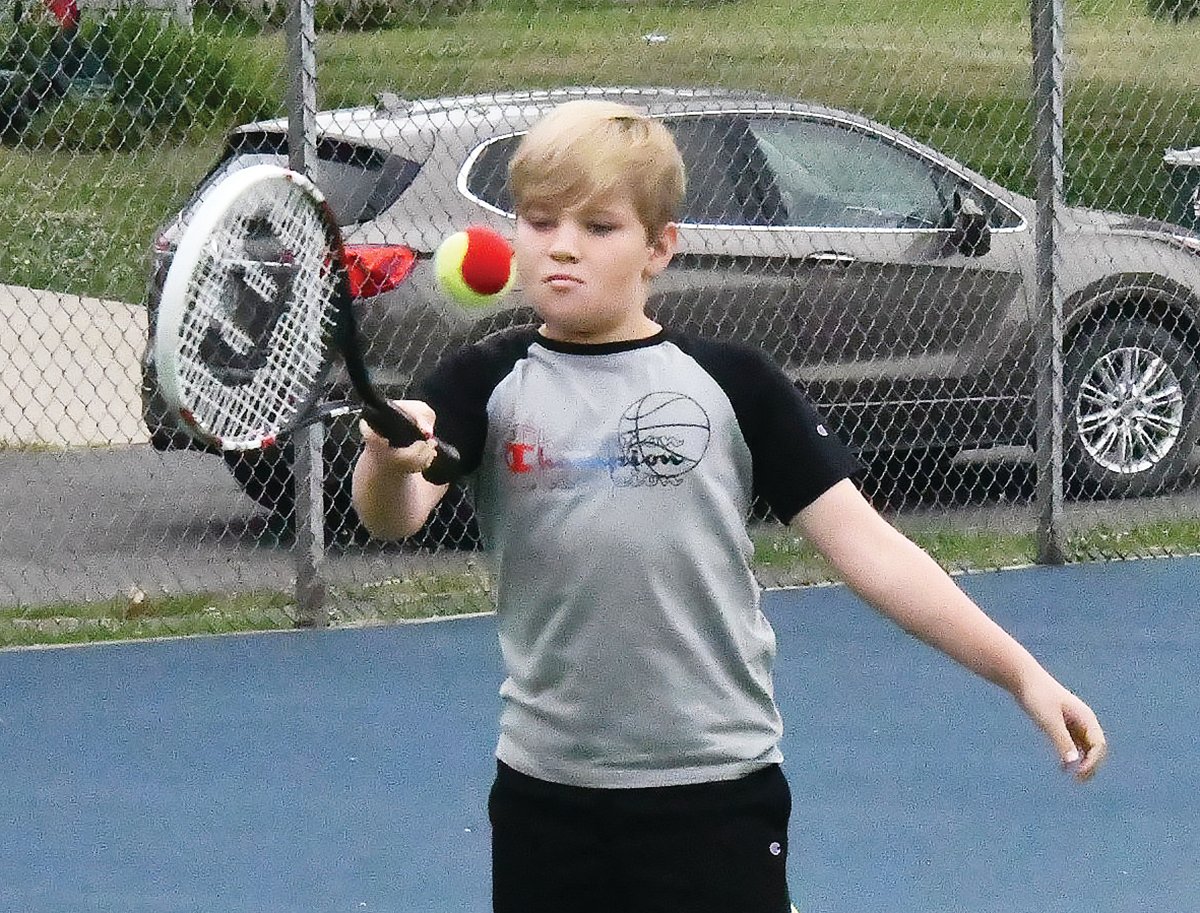 Bryson Hayes hits a shot during drills at tennis lessons on Friday, June 24, at Rothwell Park.